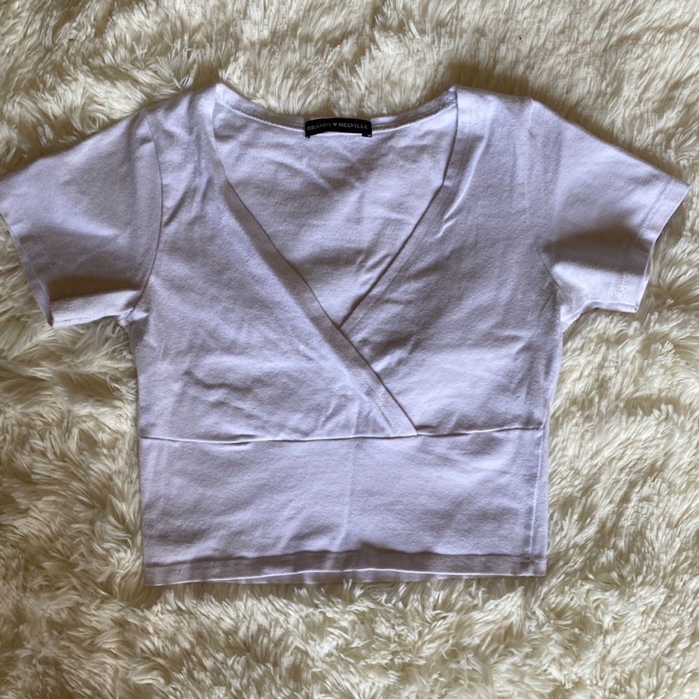 nice fitting white cross over crop top. from brandy melville